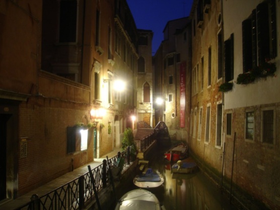 A nighttime view of a canal in Venice